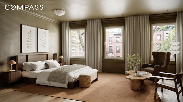 bedroom featuring crown molding and light wood finished floors