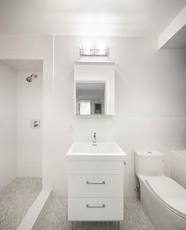 full bathroom featuring toilet, tile patterned flooring, tile walls, and vanity