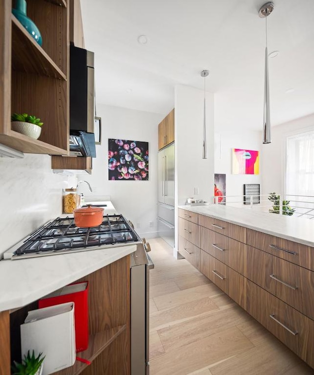 kitchen with brown cabinetry, pendant lighting, light countertops, and open shelves