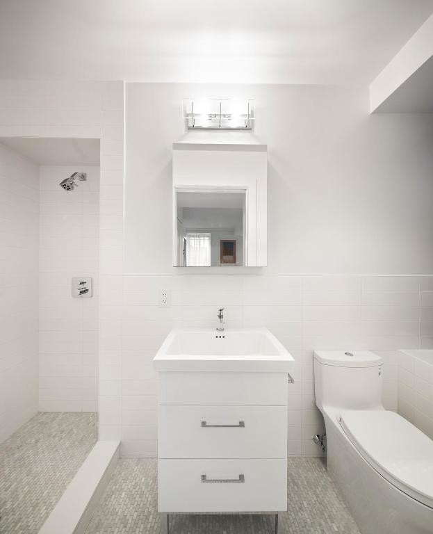 full bath featuring toilet, tile patterned flooring, tile walls, and vanity