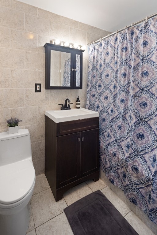 bathroom featuring tile patterned floors, toilet, a shower with curtain, tile walls, and vanity