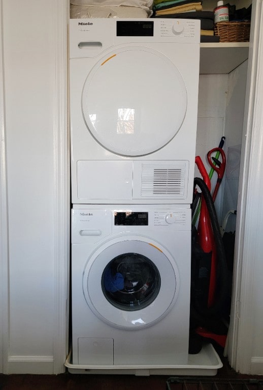 clothes washing area with stacked washer and dryer