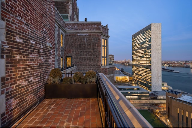 balcony featuring a view of city and a water view