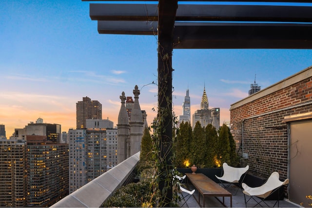 patio terrace at dusk with a view of city