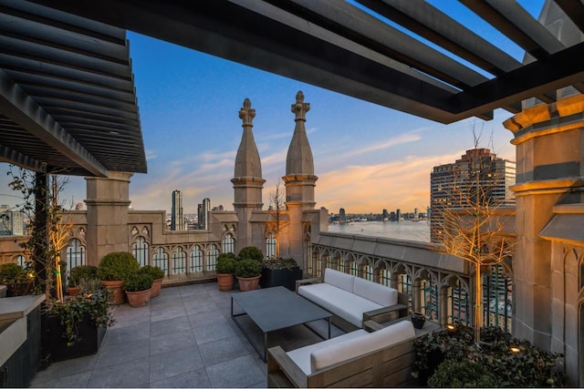 balcony at dusk featuring a pergola, a patio area, and outdoor lounge area