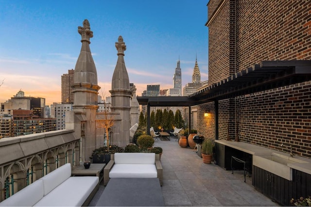 patio terrace at dusk featuring outdoor lounge area