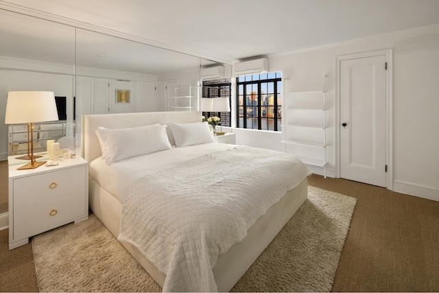 bedroom with an AC wall unit and a wall mounted air conditioner