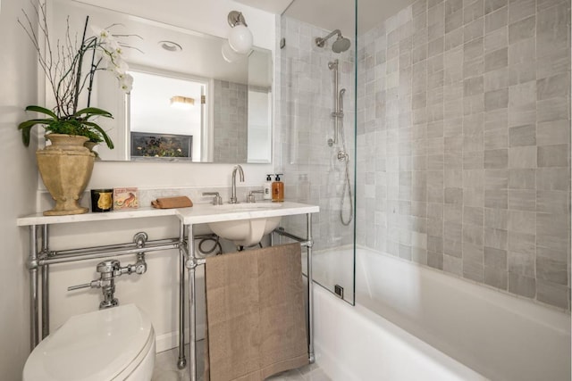 bathroom featuring toilet and tiled shower / bath combo