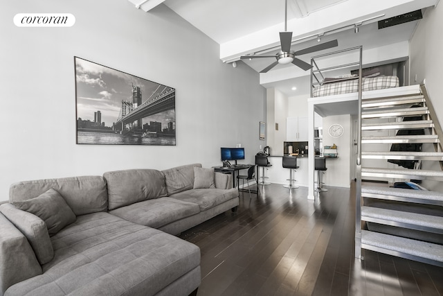 living area with visible vents, beam ceiling, a ceiling fan, wood finished floors, and rail lighting