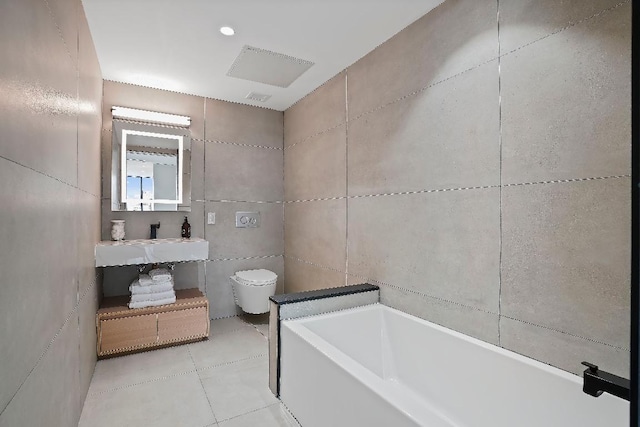 bathroom with sink, tile walls, a bath, tile patterned floors, and toilet