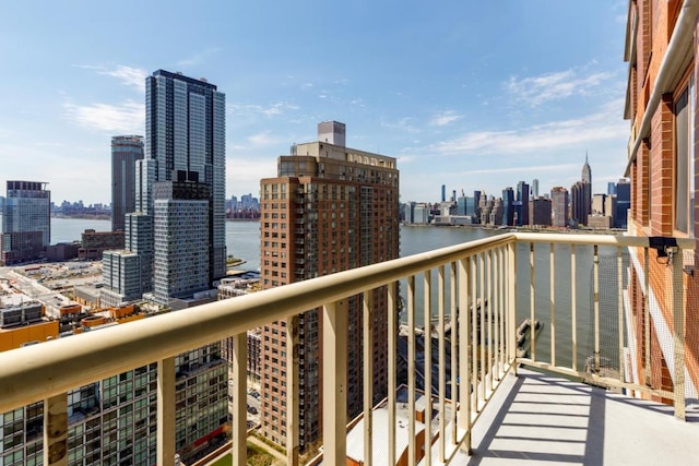 balcony featuring a water view and a city view