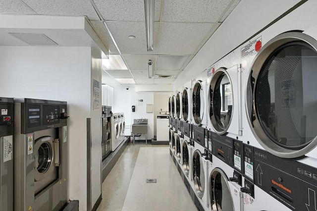 shared laundry area with washing machine and dryer, stacked washer / dryer, and visible vents