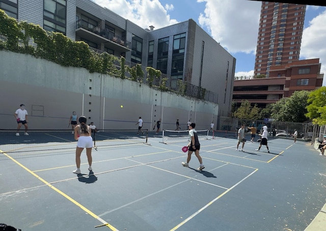 view of sport court featuring fence