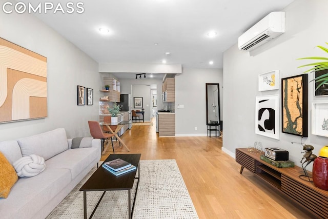 living room with light wood-type flooring and a wall mounted air conditioner