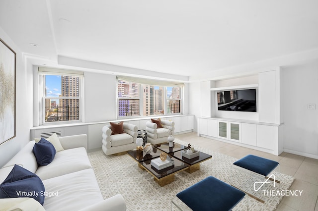 living area featuring baseboards