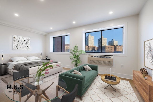 bedroom featuring a wall unit AC and light wood-type flooring