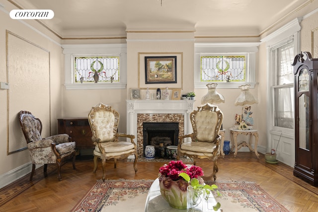 sitting room featuring ornamental molding, a fireplace with flush hearth, visible vents, and baseboards