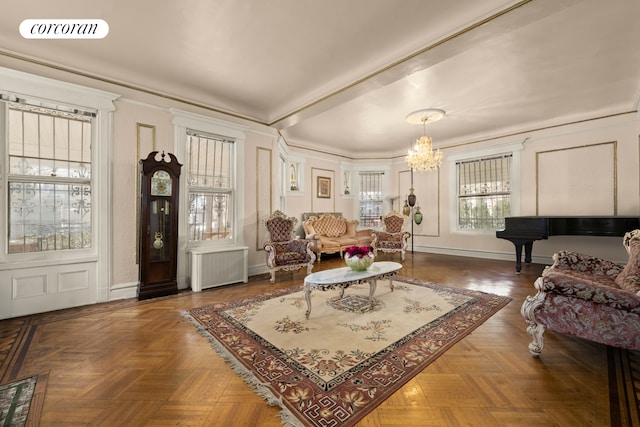 living room with a notable chandelier, radiator, visible vents, ornamental molding, and baseboards