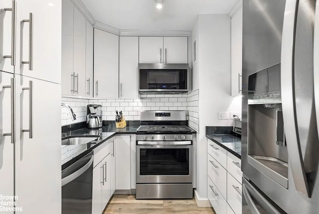 kitchen with sink, stainless steel appliances, and white cabinetry