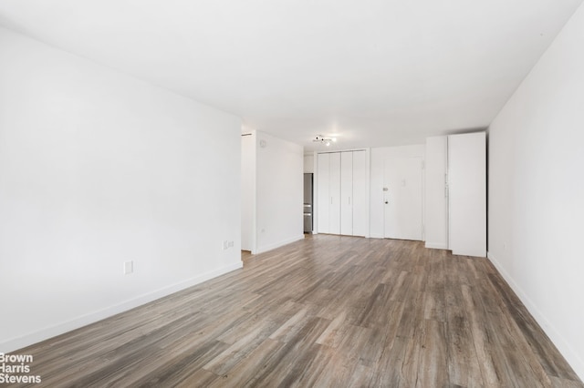 spare room with hardwood / wood-style floors