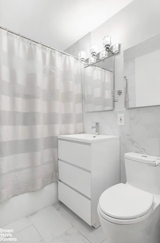 full bathroom featuring tile walls, toilet, vanity, and shower / bathtub combination with curtain