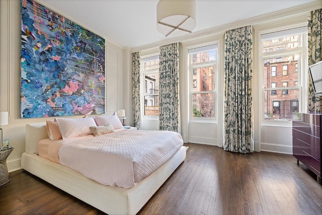 bedroom featuring dark hardwood / wood-style flooring and crown molding