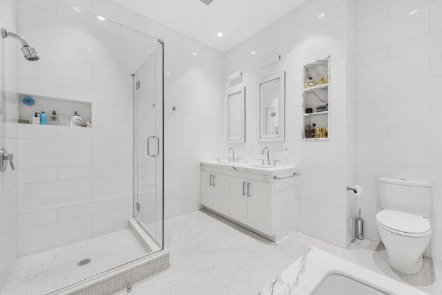 bathroom featuring a shower with door, tile patterned flooring, tile walls, and toilet