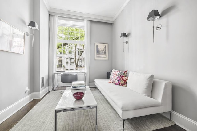 living room with hardwood / wood-style flooring and crown molding