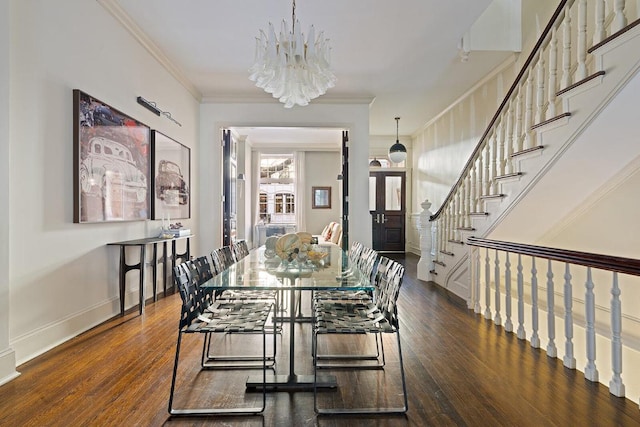 dining area featuring an inviting chandelier, ornamental molding, and dark hardwood / wood-style floors