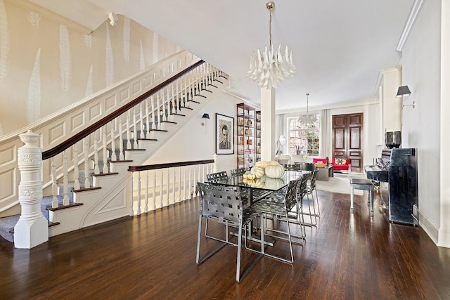 dining room with ornamental molding, dark hardwood / wood-style floors, and a notable chandelier