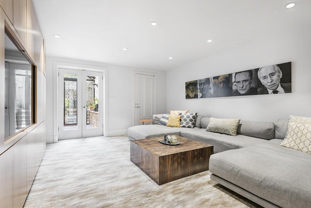 living room with light hardwood / wood-style flooring and french doors