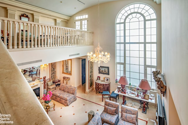 living room featuring high vaulted ceiling and a notable chandelier