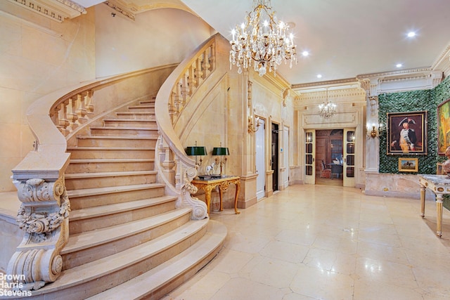 foyer with a notable chandelier and ornamental molding