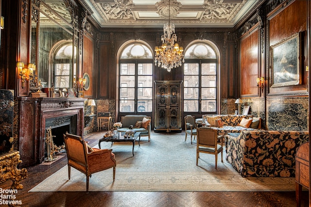 living area featuring crown molding, a high end fireplace, and a chandelier