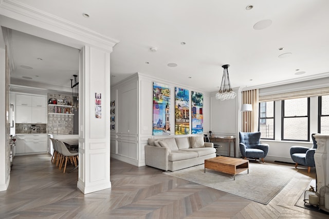 living room with ornamental molding, recessed lighting, and a notable chandelier