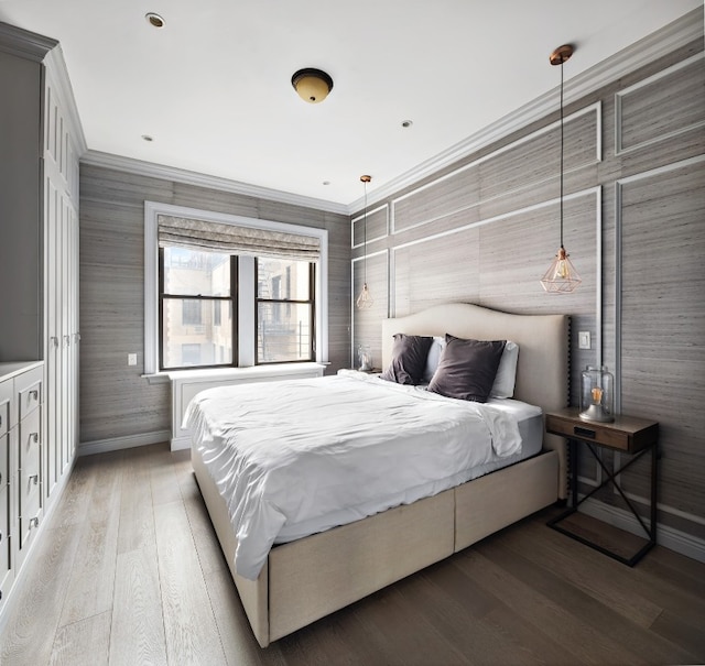 bedroom featuring wood-type flooring and ornamental molding