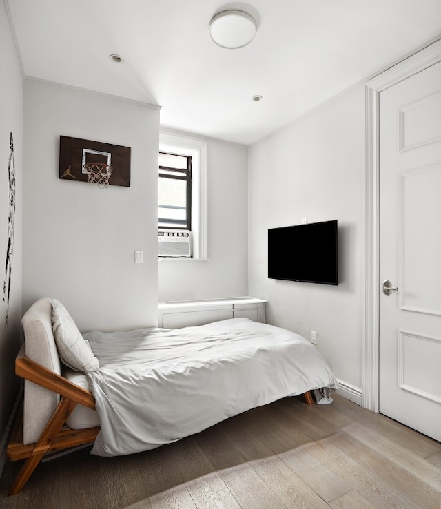 bedroom featuring cooling unit and light wood-type flooring