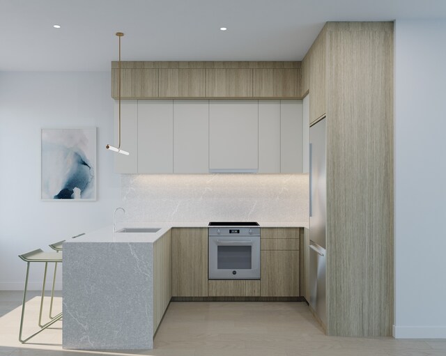 343 Menahan St Unit 2-A, New York City, NY 11237 - kitchen featuring wall oven, a sink, modern cabinets, decorative backsplash, and light countertops