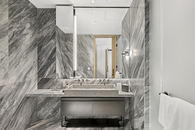 bathroom with vanity and tile walls