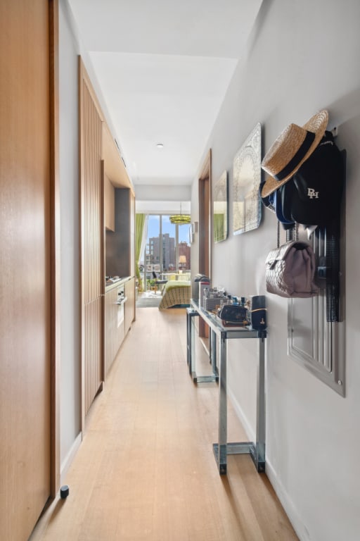 hallway featuring a view of city and baseboards