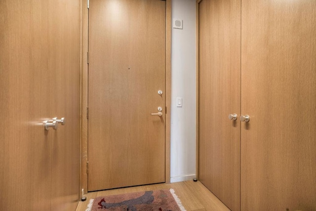 entryway with wood finished floors