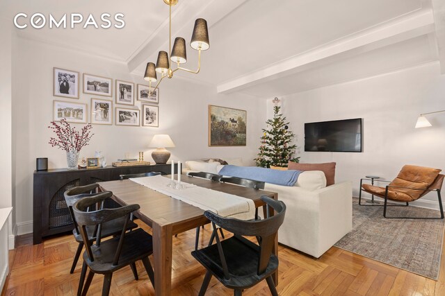 dining room with beamed ceiling, a notable chandelier, and light parquet floors