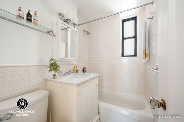 bathroom featuring toilet,  shower combination, vanity, and tile walls