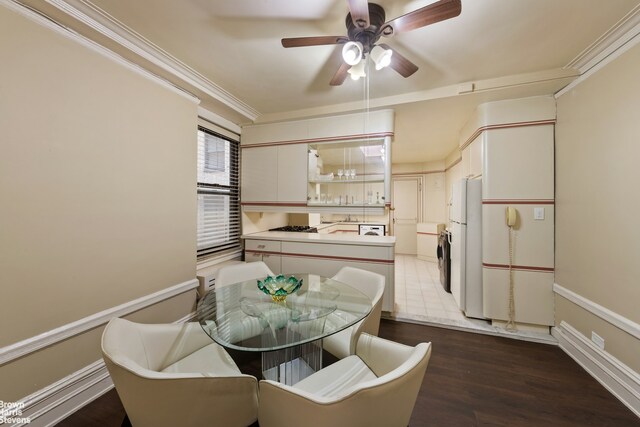 dining area featuring ceiling fan, dark wood-type flooring, baseboards, and crown molding