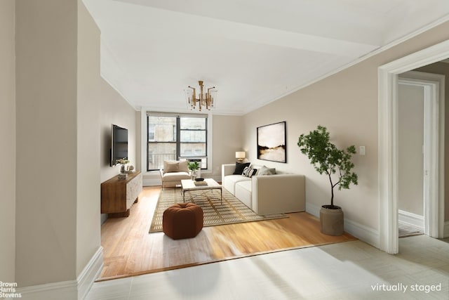 living room featuring crown molding, a notable chandelier, and light hardwood / wood-style floors