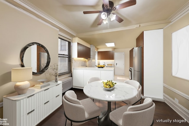 dining room with a ceiling fan, baseboards, ornamental molding, and dark wood-type flooring