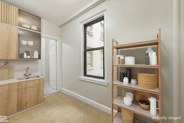 bathroom featuring vanity, baseboards, and tile patterned floors