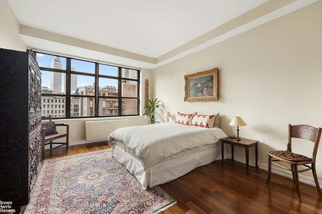 bedroom with dark hardwood / wood-style floors