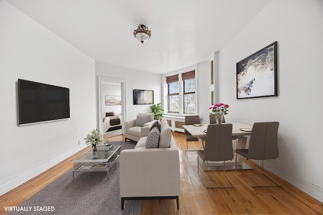 living area with hardwood / wood-style flooring and baseboards