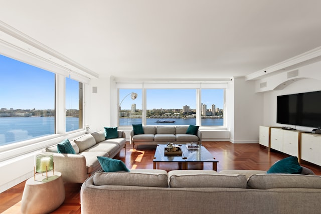 living room featuring ornamental molding, a water view, and parquet floors